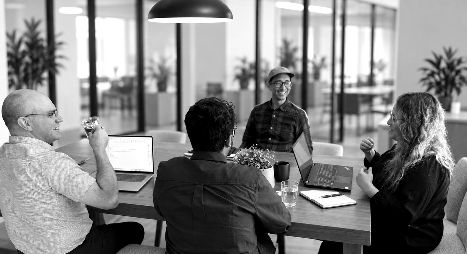 Members of the Think Beyond team collaborating around a conference table